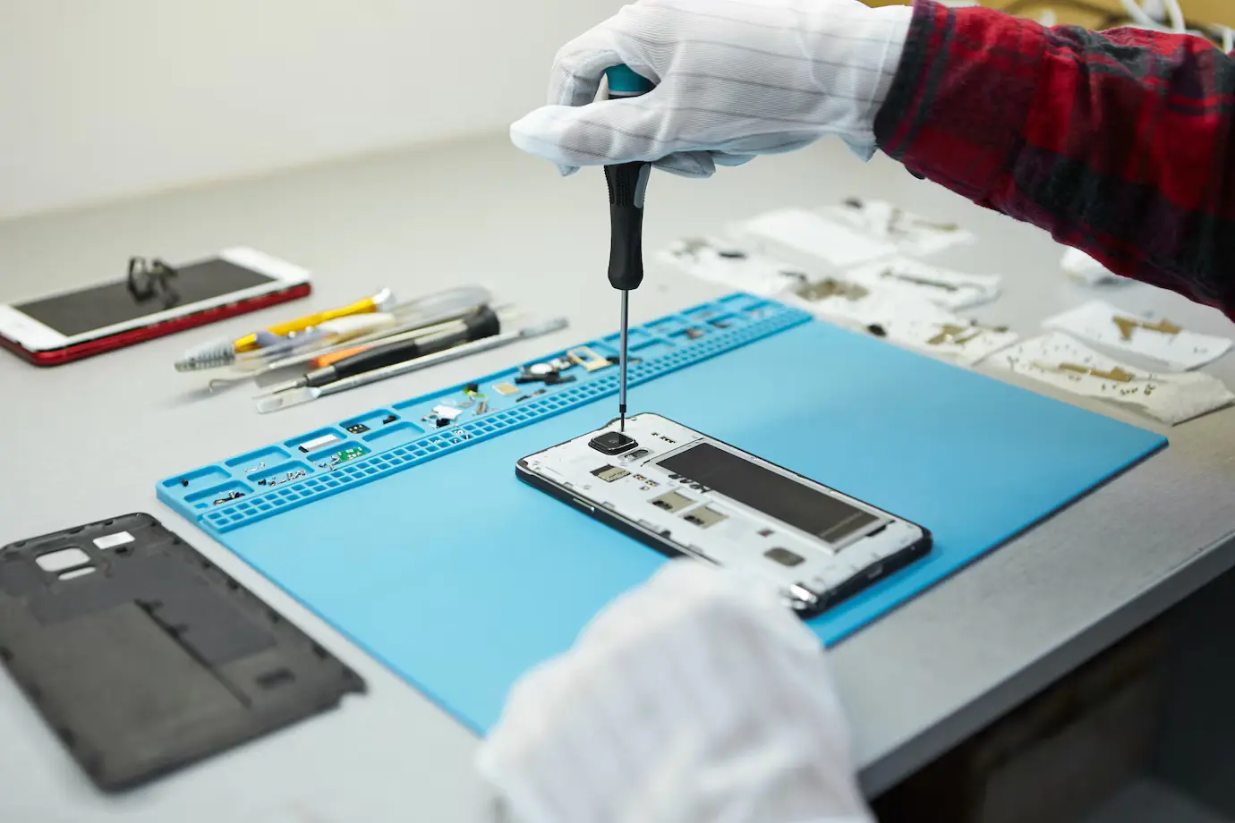 Technician working on a smartphone motherboard